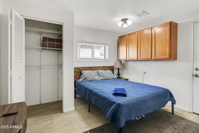 7520 E Papago Dr, Scottsdale, AZ 85257 - bedroom featuring baseboards, visible vents, a closet, and wood finish floors