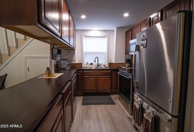 7411 N Toya Vista Rd, Payson, AZ 85541 - kitchen with appliances with stainless steel finishes, dark countertops, a sink, light wood finished floors, and recessed lighting