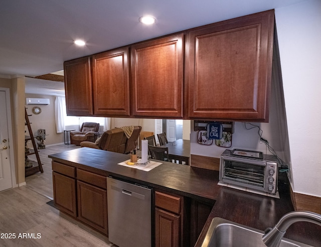 7411 N Toya Vista Rd, Payson, AZ 85541 - kitchen featuring dishwasher, a sink, dark countertops, light wood-type flooring, and a wall mounted air conditioner