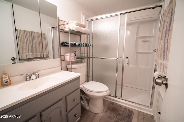 7411 N Toya Vista Rd, Payson, AZ 85541 - bathroom with a shower stall, toilet, vanity, and wood finished floors