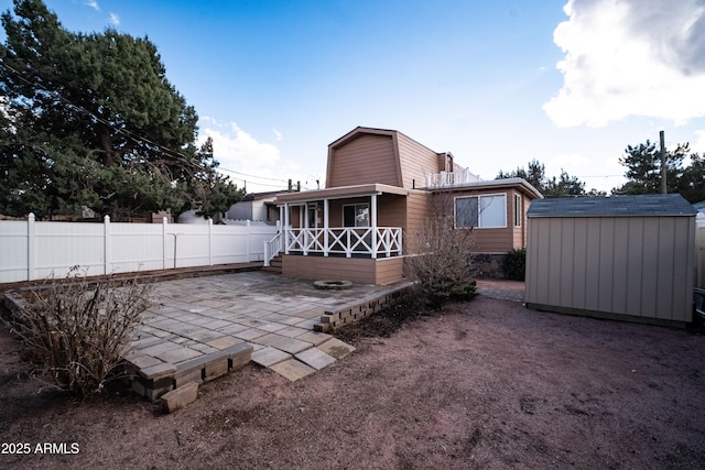 7411 N Toya Vista Rd, Payson, AZ 85541 - back of house featuring a storage unit, an outdoor structure, a patio, and fence