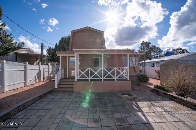 7411 N Toya Vista Rd, Payson, AZ 85541 - rear view of property with a porch, a fenced backyard, a shed, an outdoor structure, and a patio area