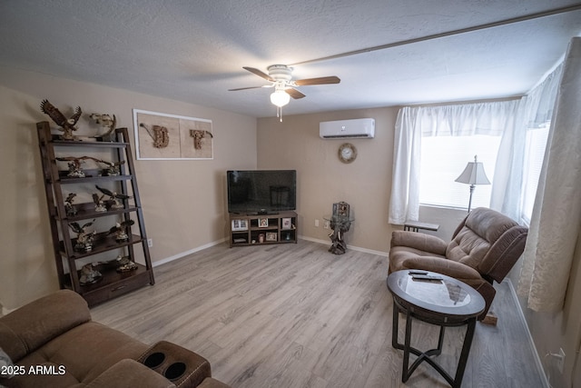 7411 N Toya Vista Rd, Payson, AZ 85541 - living room with an AC wall unit, ceiling fan, wood finished floors, baseboards, and a textured ceiling