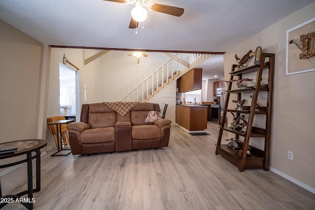 7411 N Toya Vista Rd, Payson, AZ 85541 - living area with stairs, light wood finished floors, ceiling fan, and baseboards