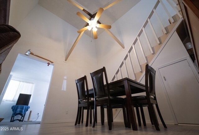 7411 N Toya Vista Rd, Payson, AZ 85541 - dining room with ceiling fan, stairs, a towering ceiling, and wood finished floors
