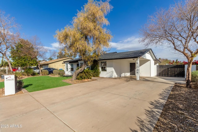 single story home with a front yard and a garage