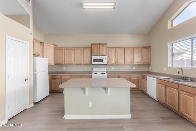 kitchen featuring white appliances, light hardwood / wood-style floors, a center island, light brown cabinetry, and sink