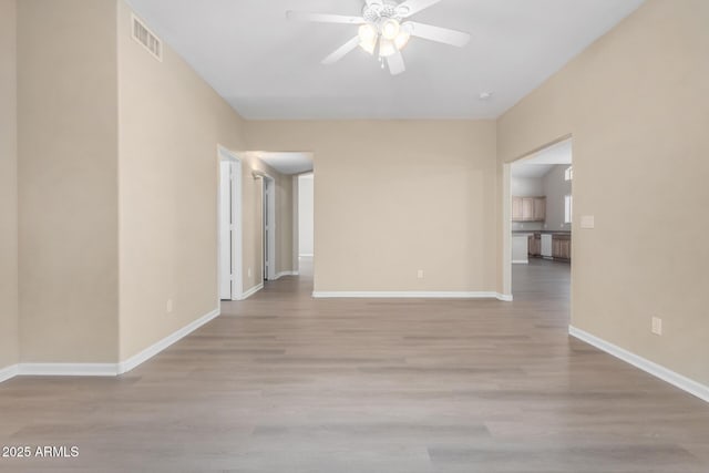 unfurnished room featuring light wood-type flooring and ceiling fan