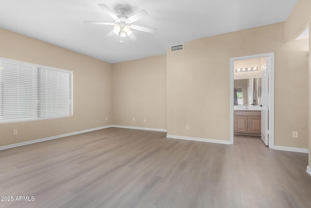 unfurnished room featuring ceiling fan, light hardwood / wood-style flooring, and sink