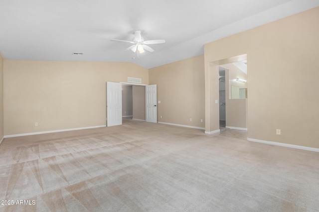 spare room featuring ceiling fan, light colored carpet, and lofted ceiling