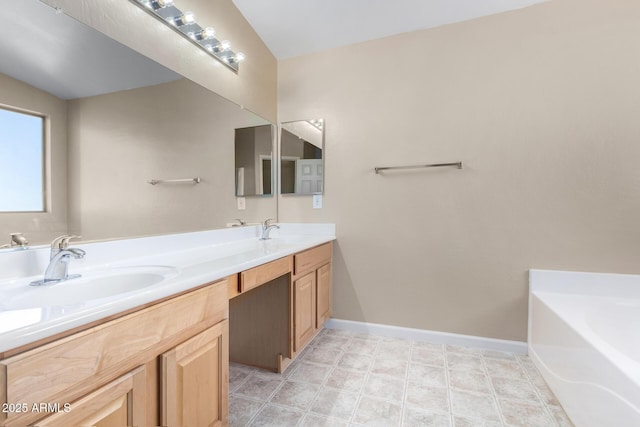 bathroom featuring vanity and a tub