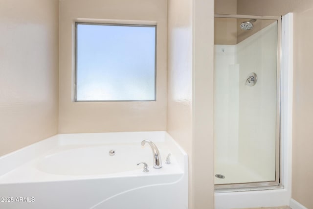 bathroom with shower with separate bathtub