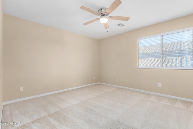 carpeted empty room featuring ceiling fan