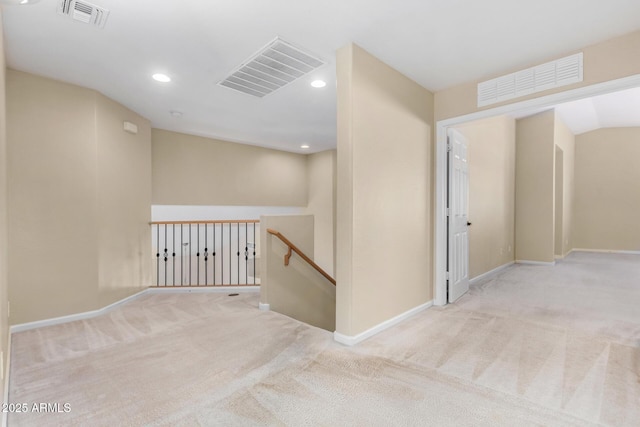 corridor with light colored carpet