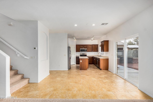 kitchen featuring sink, a kitchen island, and appliances with stainless steel finishes