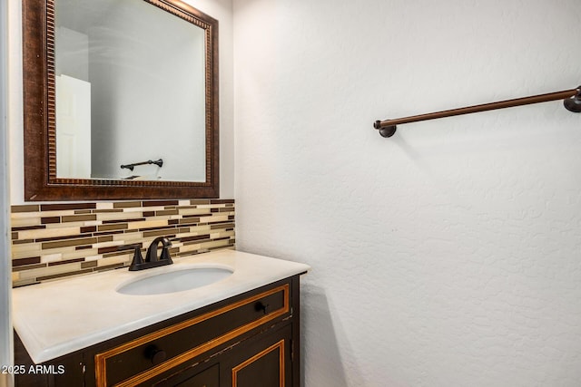 bathroom with tasteful backsplash and vanity