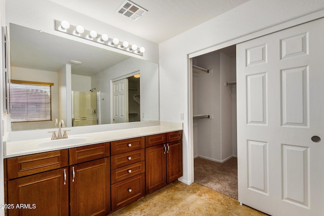 bathroom with vanity and a shower