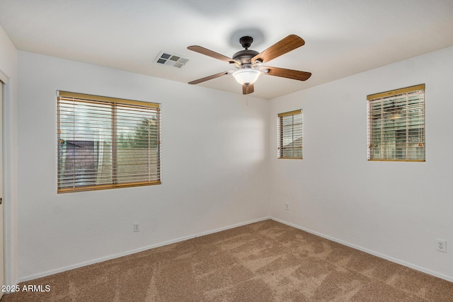 unfurnished room featuring ceiling fan and carpet