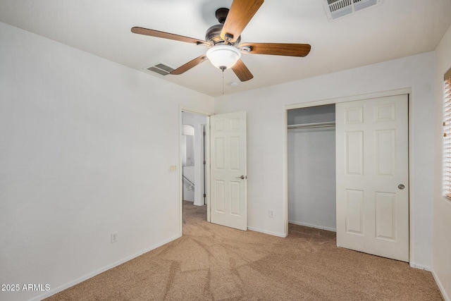 unfurnished bedroom with light carpet, ceiling fan, and a closet