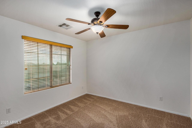 spare room with carpet and ceiling fan