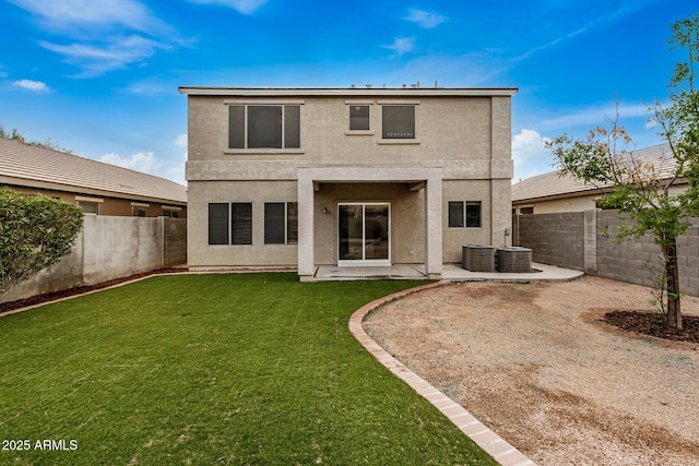 back of house with a yard and a patio