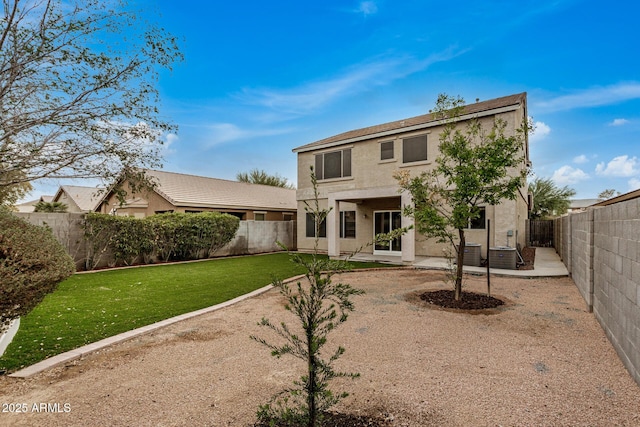 rear view of property featuring a yard and a patio