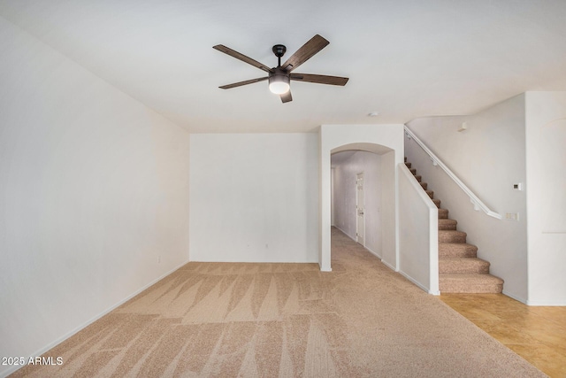 carpeted empty room featuring ceiling fan