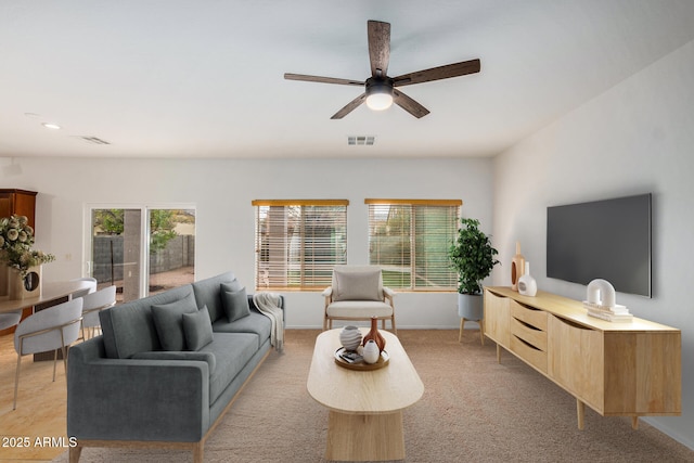 living room with ceiling fan and light carpet