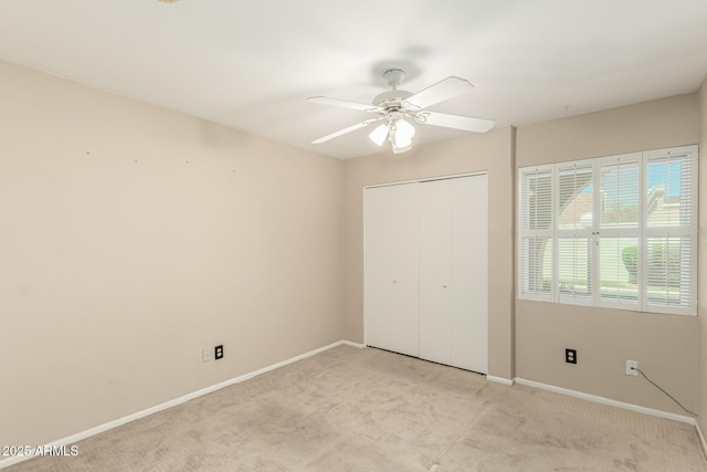 6025 N 10th Pl, Phoenix, AZ 85014 - unfurnished bedroom with light colored carpet, a closet, and ceiling fan
