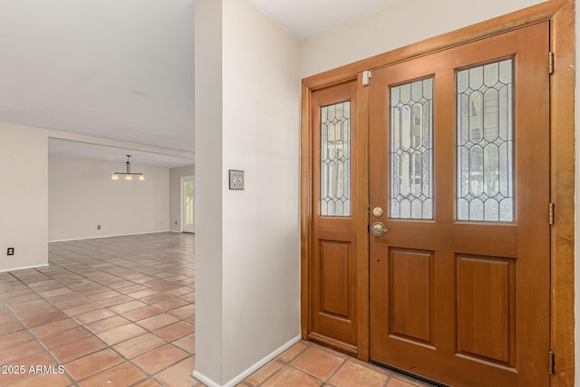 6025 N 10th Pl, Phoenix, AZ 85014 - foyer with light tile patterned floors and a chandelier
