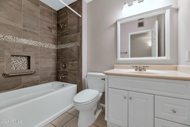 full bathroom featuring vanity, toilet, tile patterned floors, and tiled shower / bath