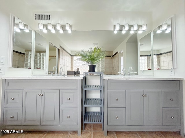 full bathroom featuring a sink, visible vents, and two vanities