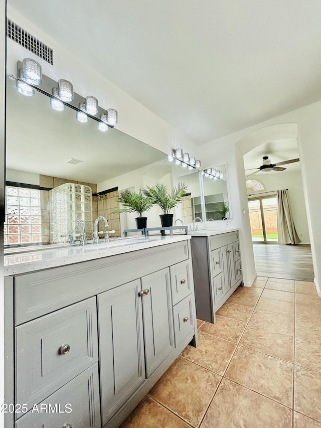 full bathroom with tile patterned floors, two vanities, and ceiling fan