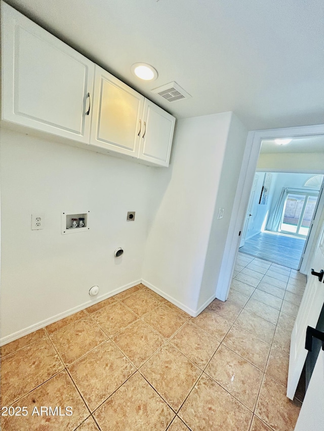 clothes washing area featuring light tile patterned floors, visible vents, gas dryer hookup, cabinet space, and washer hookup