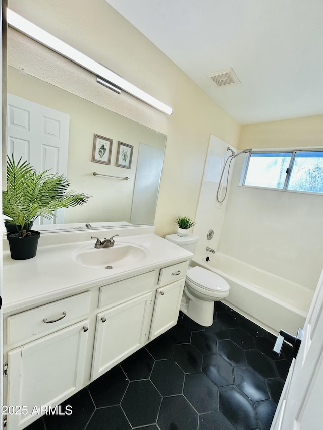 full bath featuring vanity, washtub / shower combination, visible vents, tile patterned floors, and toilet