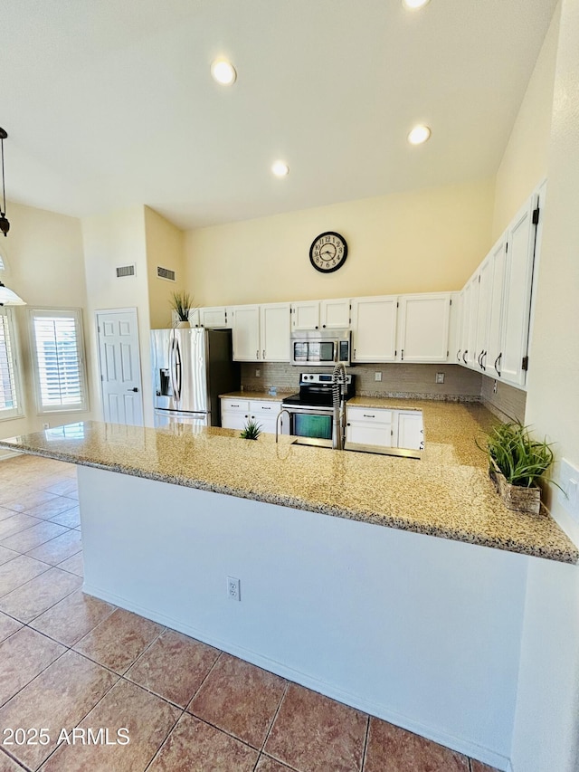 kitchen featuring light stone counters, light tile patterned floors, and appliances with stainless steel finishes