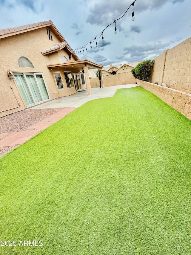 view of yard featuring a patio and a fenced backyard