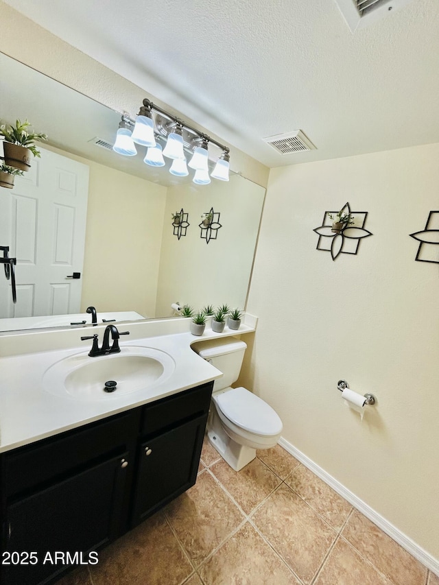 half bath with vanity, baseboards, visible vents, tile patterned flooring, and toilet