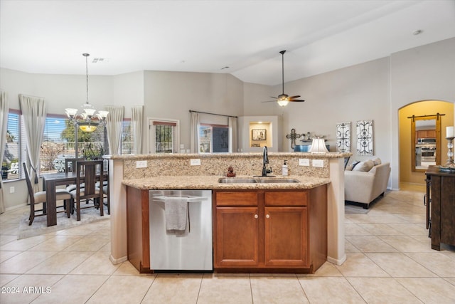 kitchen with dishwasher, a kitchen island with sink, hanging light fixtures, sink, and light tile patterned flooring