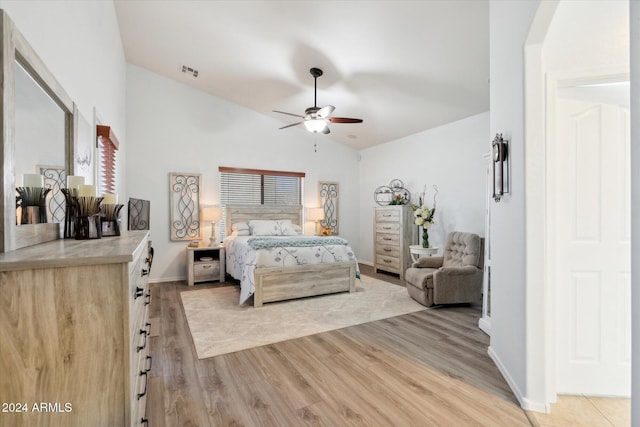 bedroom featuring light hardwood / wood-style flooring, ceiling fan, and lofted ceiling