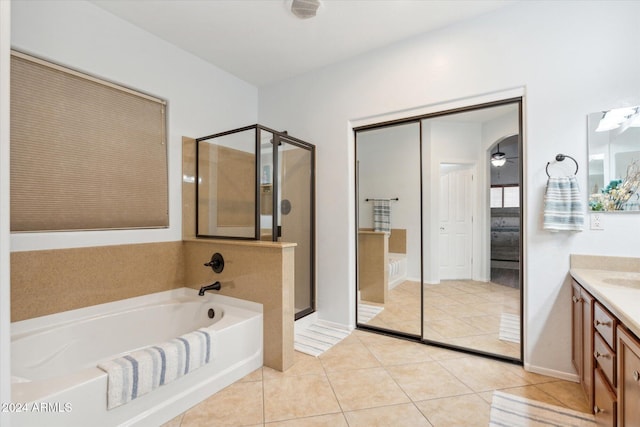 bathroom with tile patterned flooring, vanity, ceiling fan, and independent shower and bath