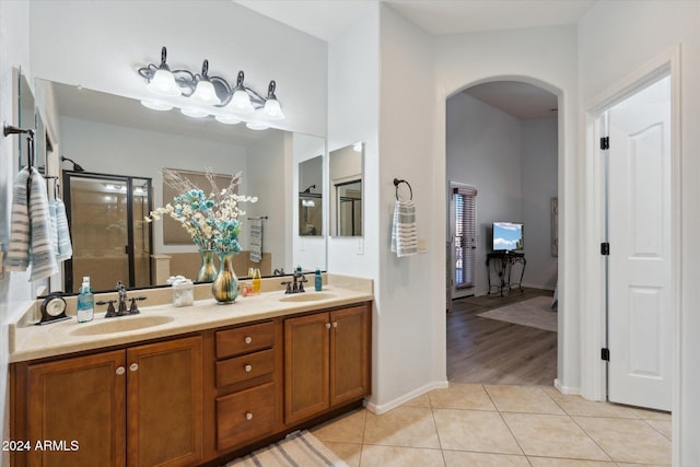 bathroom with tile patterned floors, vanity, and a shower with shower door