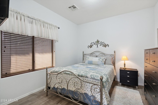 bedroom with dark wood-type flooring