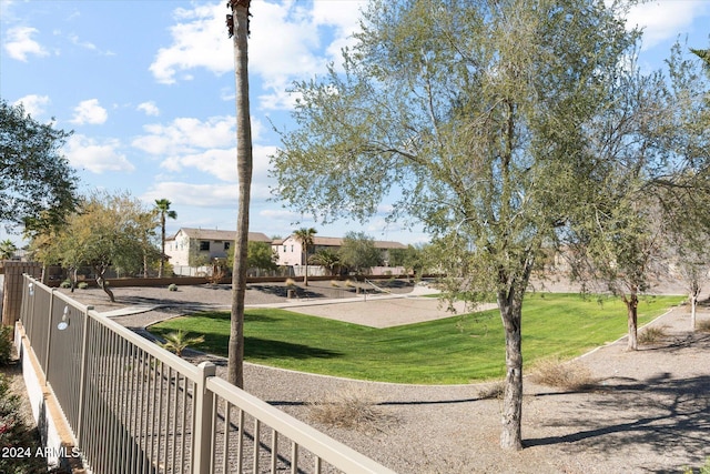 view of home's community with volleyball court and a yard