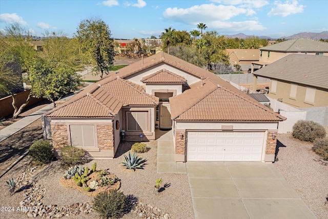 view of front of property with a mountain view and a garage