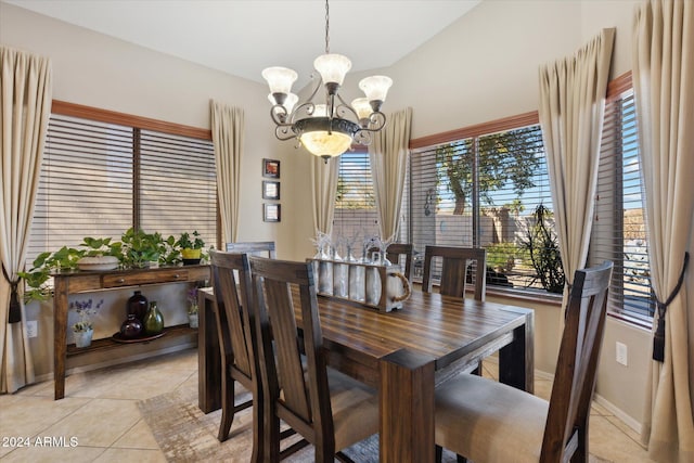 tiled dining area featuring plenty of natural light and a chandelier