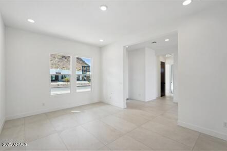 spare room featuring light tile patterned floors, recessed lighting, and baseboards