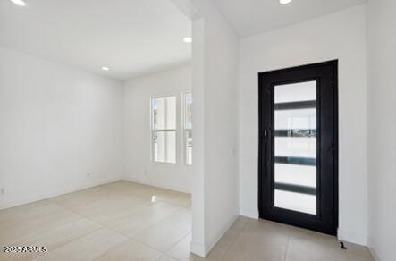 tiled foyer featuring recessed lighting