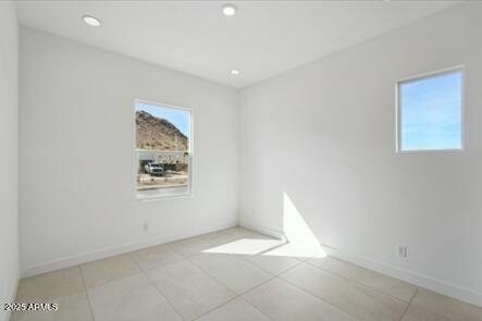 spare room featuring recessed lighting, baseboards, and light tile patterned flooring