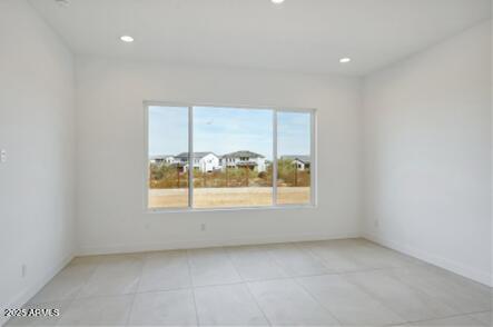 empty room featuring light tile patterned floors and recessed lighting